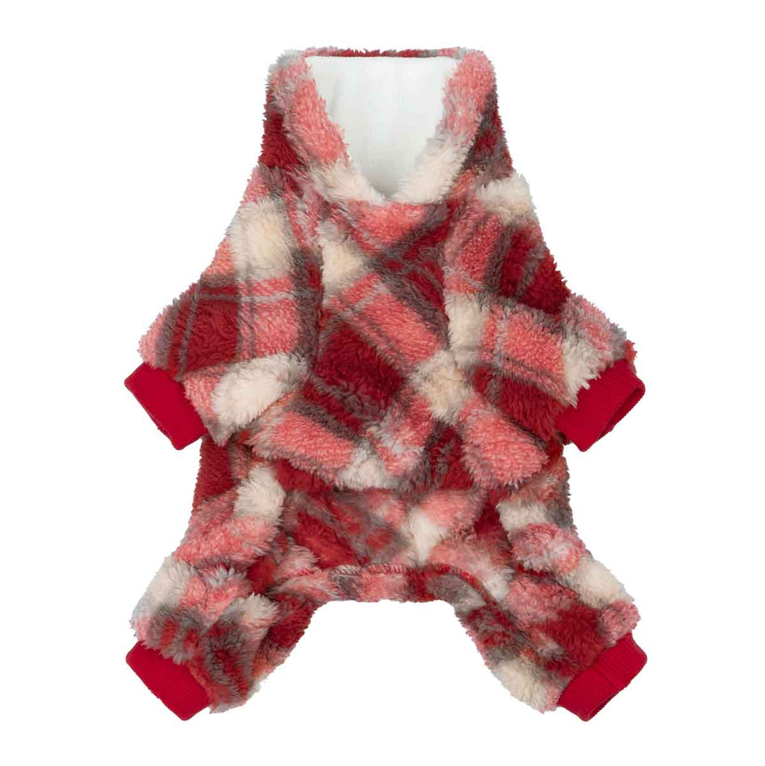 Dog in red flannel pajamas lounging on bed, cozy winter mood
