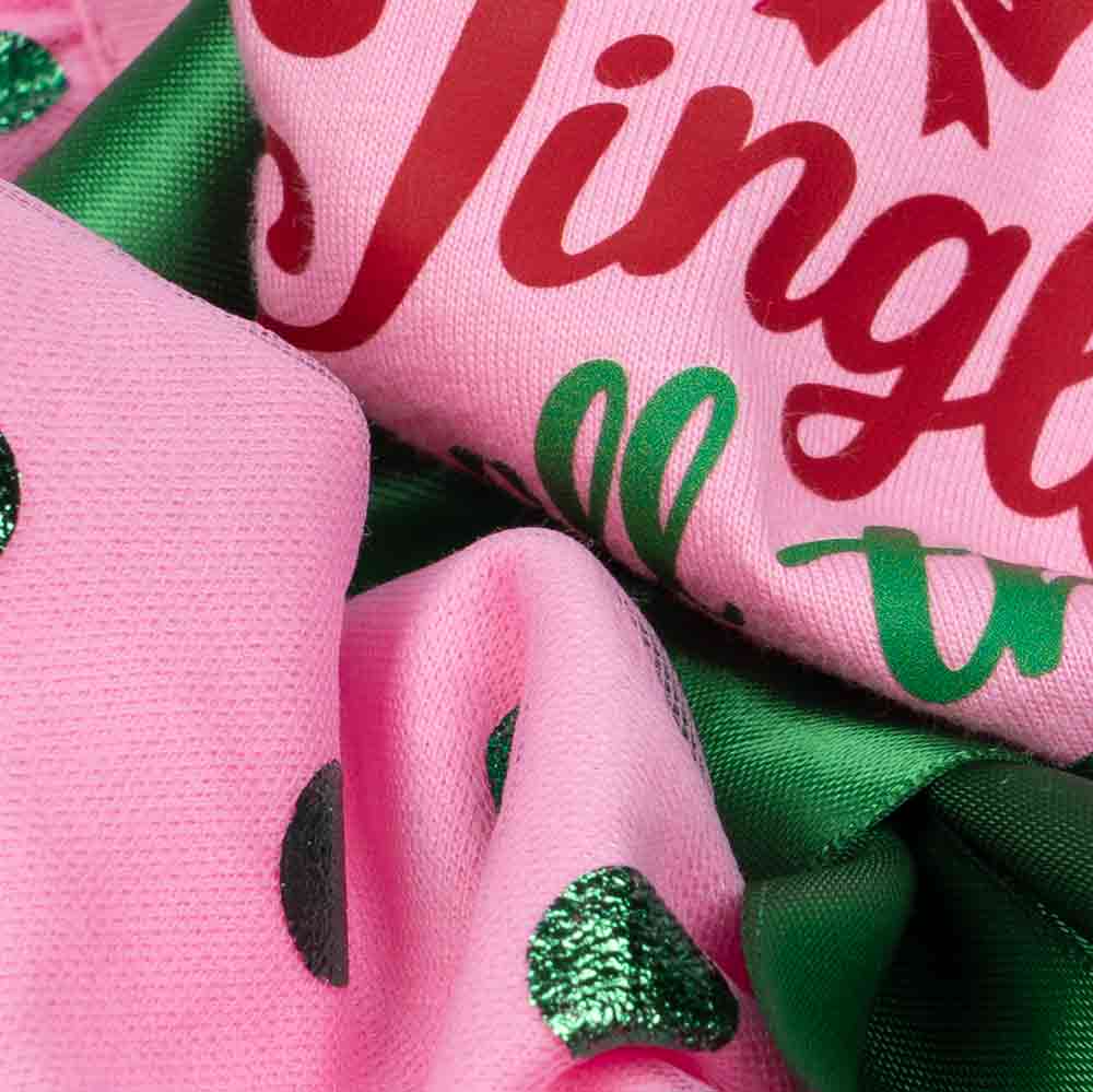 Close-up of cotton fabric and glitter dots on holiday-themed dog dress.