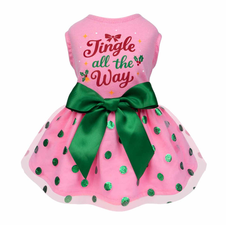 Pink dog dress with green bow and “Jingle all the Way” print for festive holiday look.