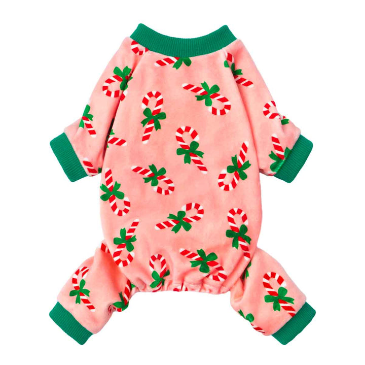 Festive dog pajamas with candy cane and green bow prints on pink fabric.