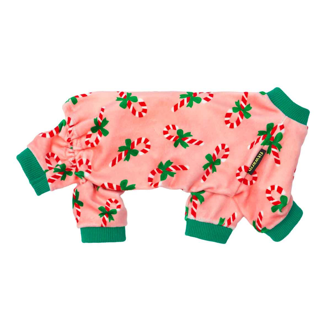 Soft pink dog pajamas decorated with holiday candy canes and festive accents.