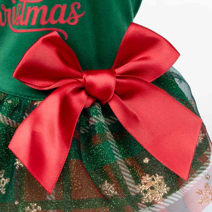 Close-up detail of Christmas dog dress with large red satin bow on plaid glitter skirt.