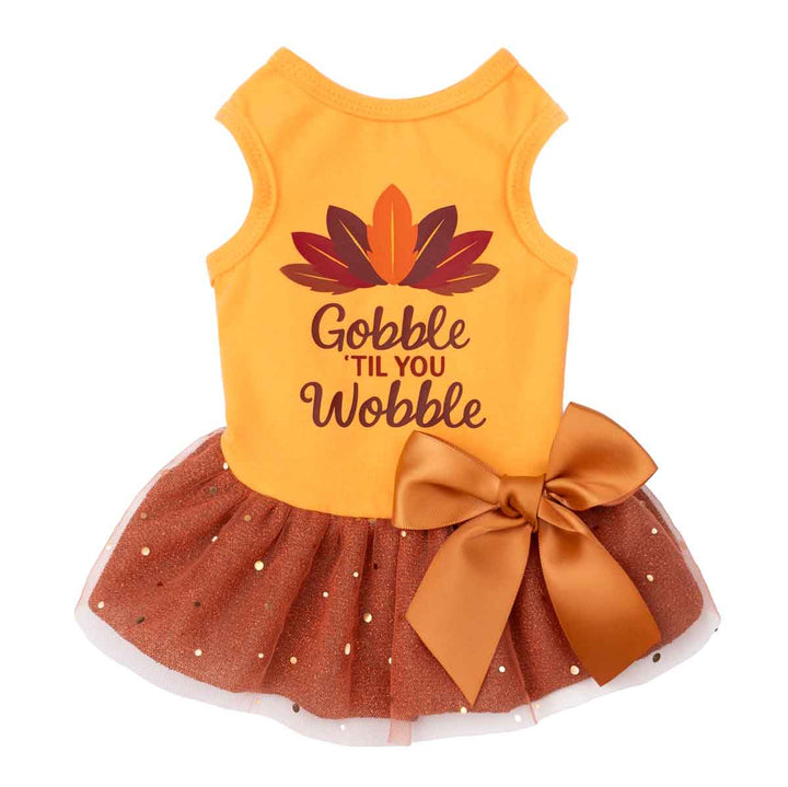 Thanksgiving dog dress in orange with “Gobble ’Til You Wobble” print and brown bow tutu.