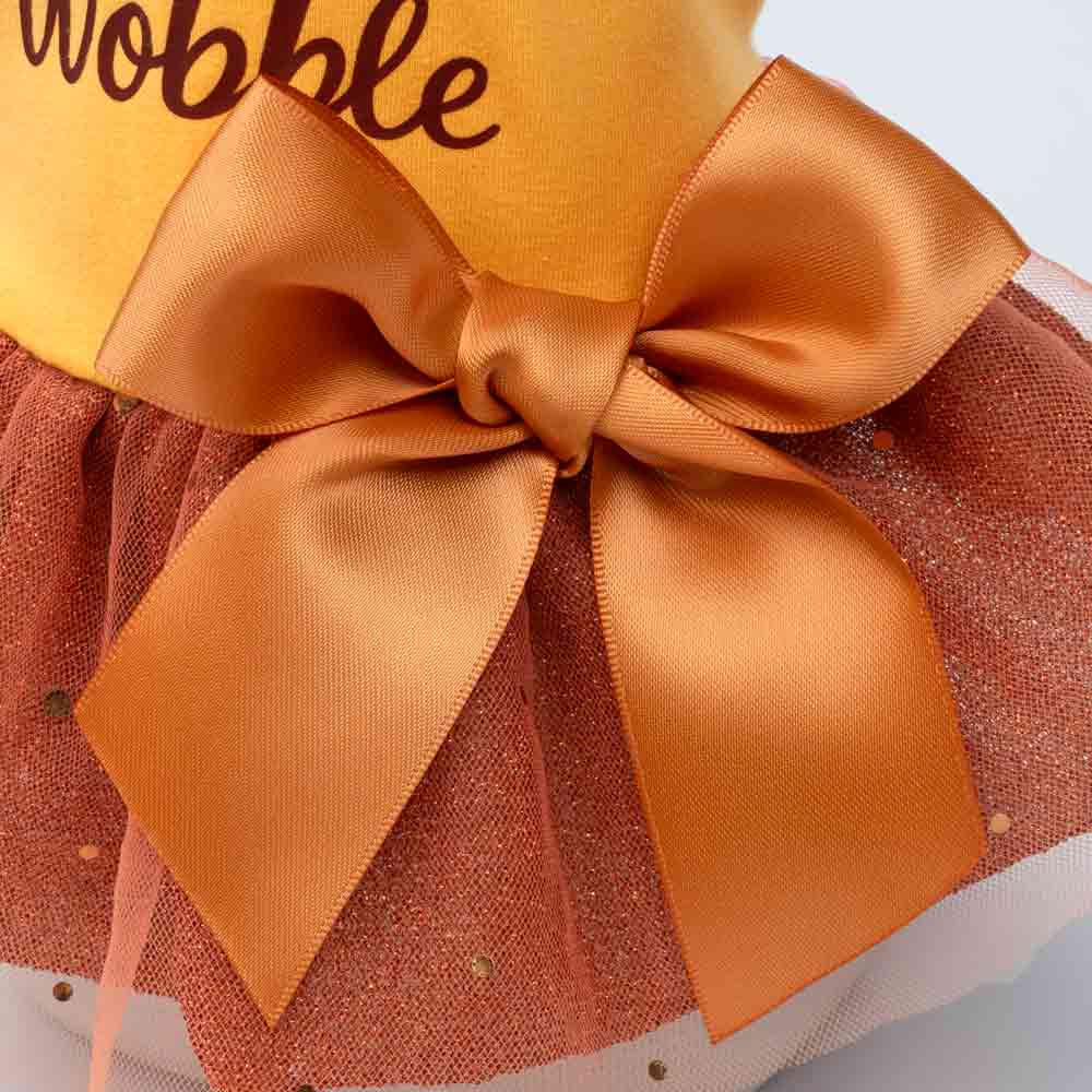Close-up of Thanksgiving dog dress with large satin bow detail.