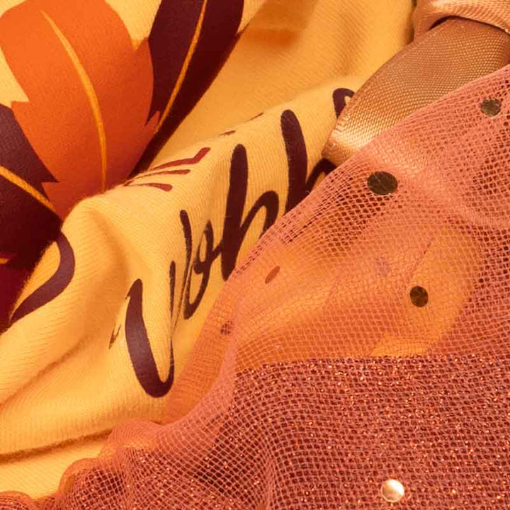 Thanksgiving dog dress fabric close-up with glitter tulle and printed text.