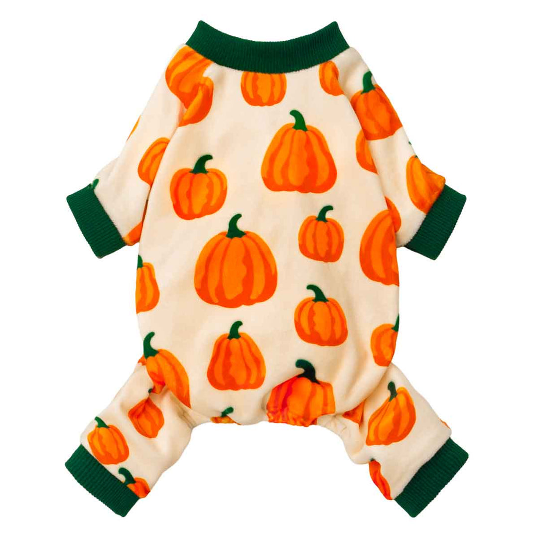 Cream-colored dog pajamas with orange pumpkin prints and green ribbed cuffs.