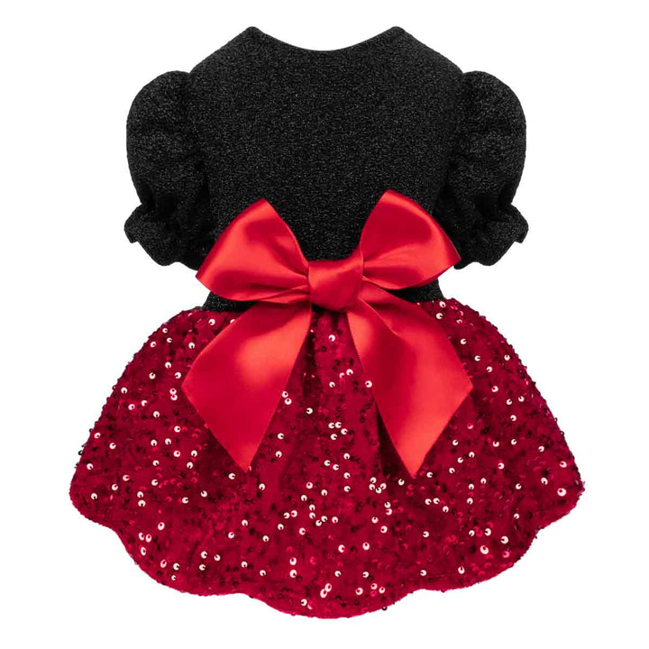 Festive dog dress with glittery black top, red sequin skirt, and oversized red bow.