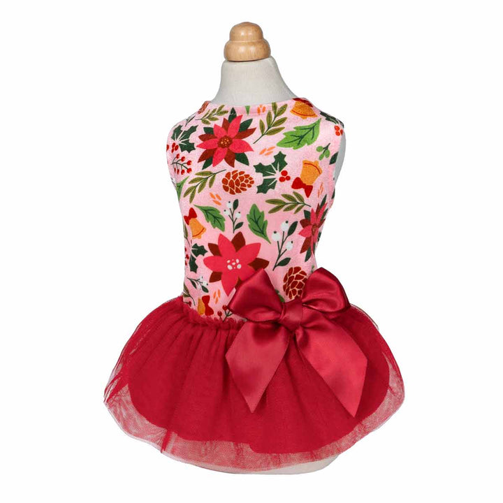 Mannequin wearing Christmas-themed dog dress with floral prints and red satin bow.