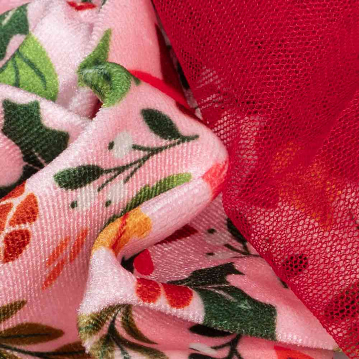Close-up of floral velvet and red tulle fabric from Christmas dog dress.
