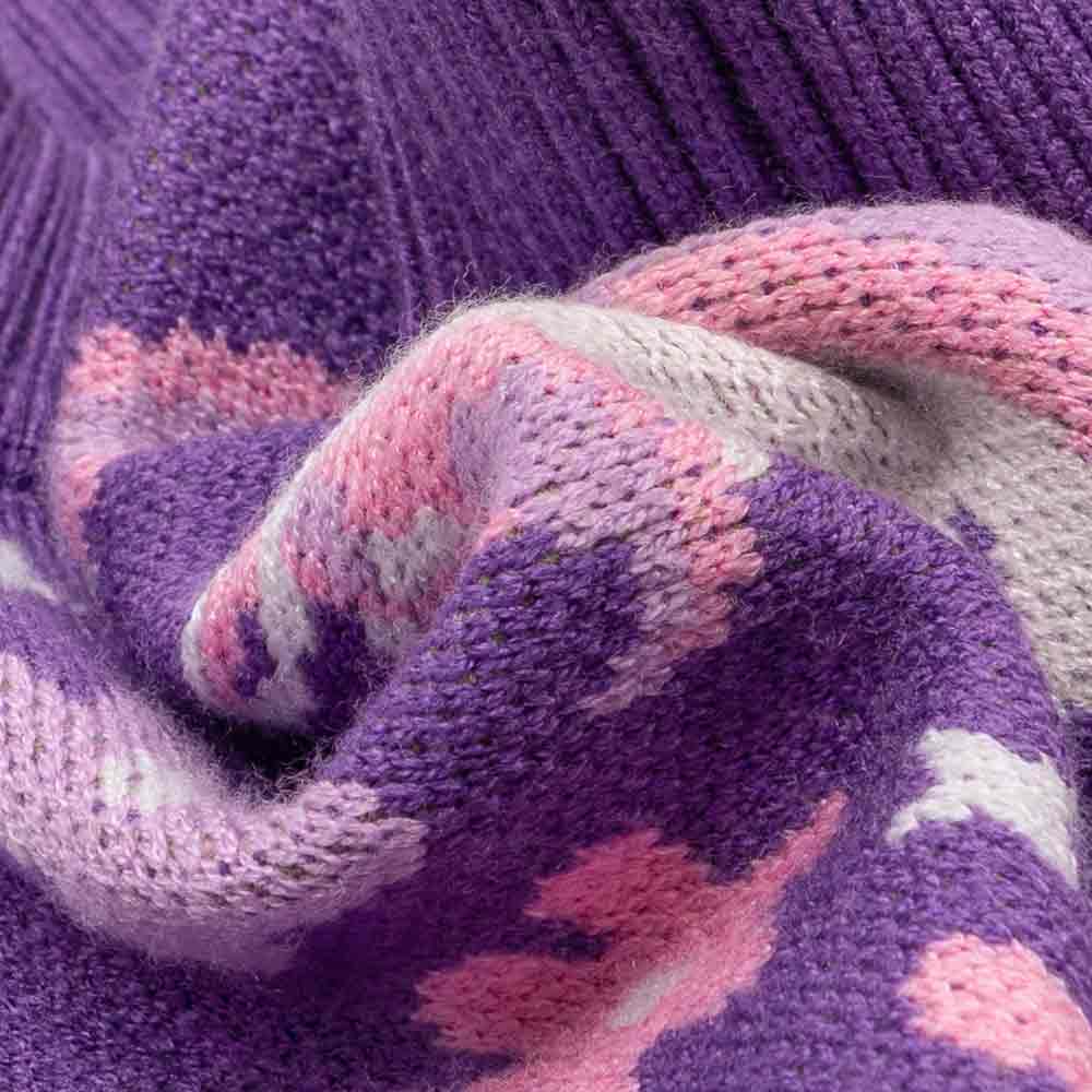 Close-up view of purple and pink angora wool fabric from a soft unicorn dog sweater.