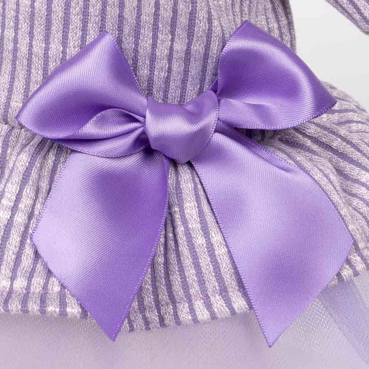 Close-up of purple satin bow detail on a ribbed lavender dog dress with tulle skirt.