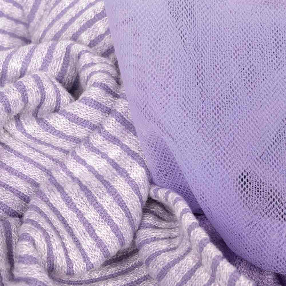 Textured view of ribbed lavender knit fabric and soft tulle material from a purple dog dress.