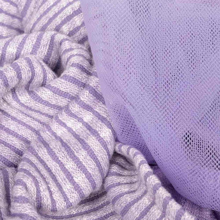 Textured view of ribbed lavender knit fabric and soft tulle material from a purple dog dress.