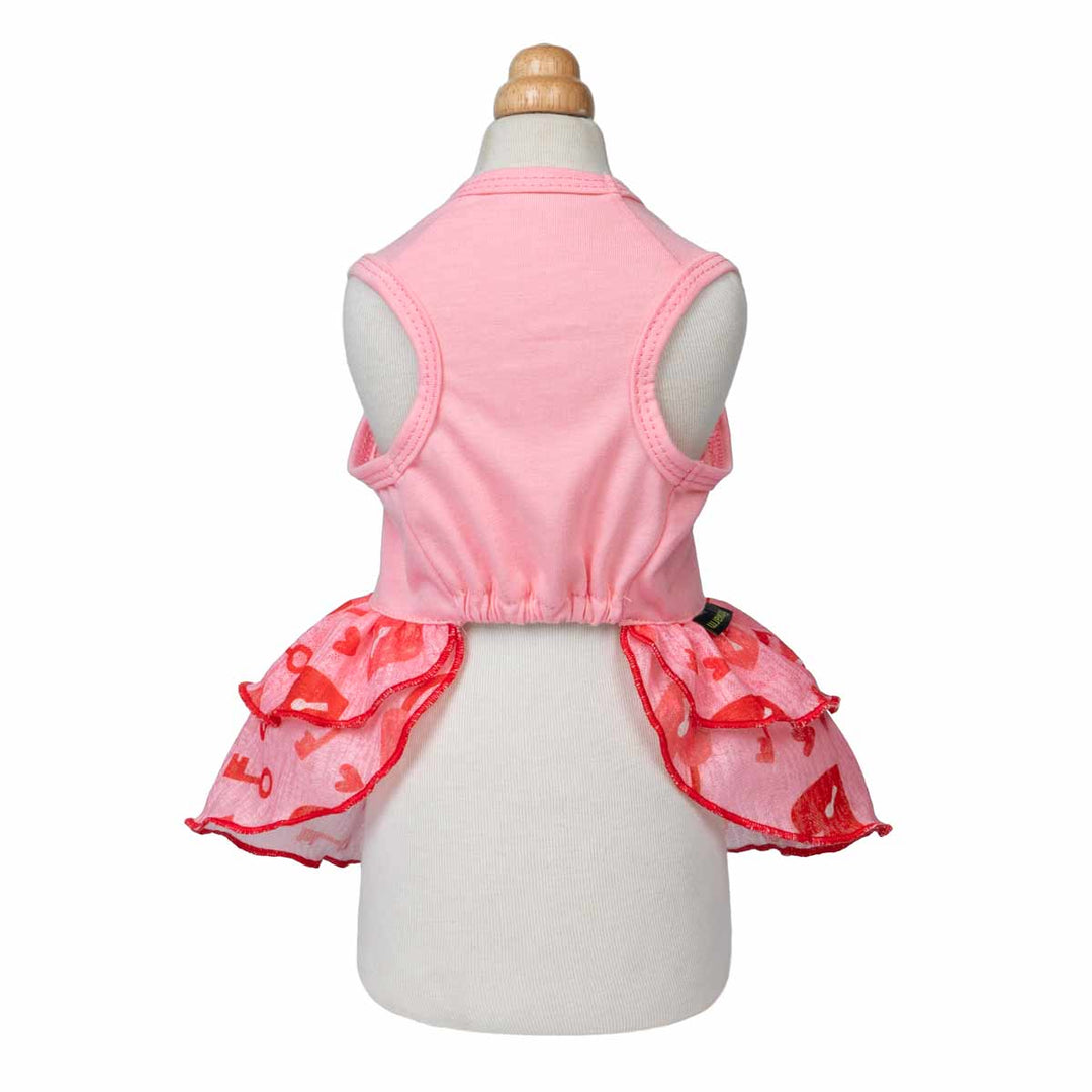 Pink dog dress shown from the back on a mannequin with layered red ruffle skirt.