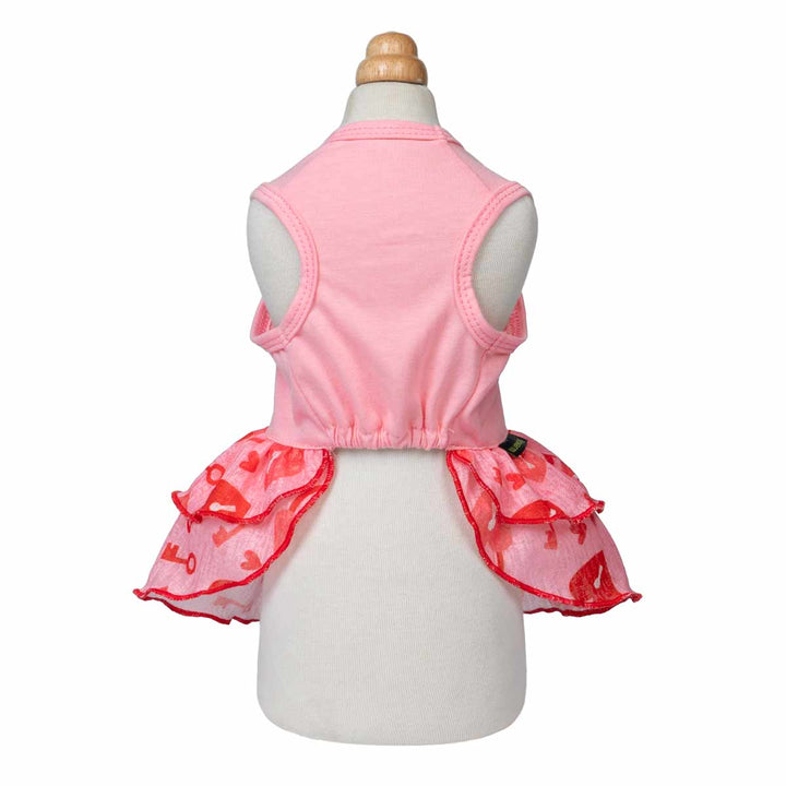 Pink dog dress shown from the back on a mannequin with layered red ruffle skirt.