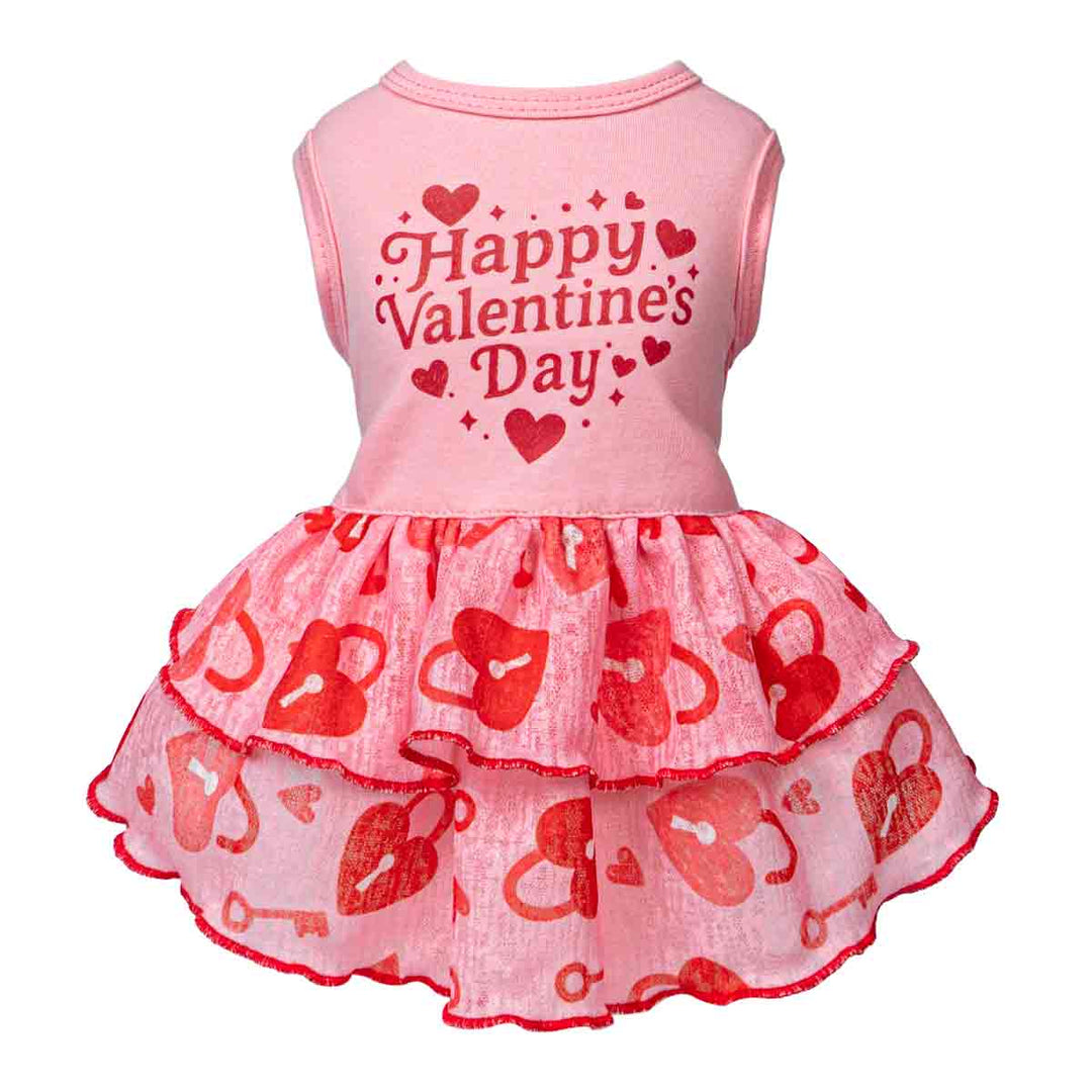 Pink dog dress featuring Happy Valentine’s Day text and red lock-and-key ruffle layers.