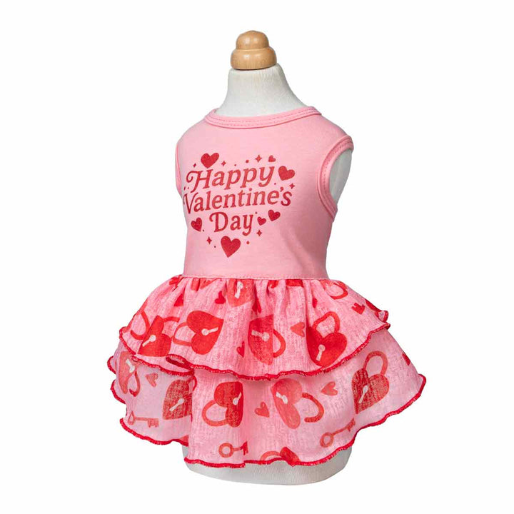 Pink Valentine dog dress on mannequin with heart-and-key ruffle skirt and printed message.