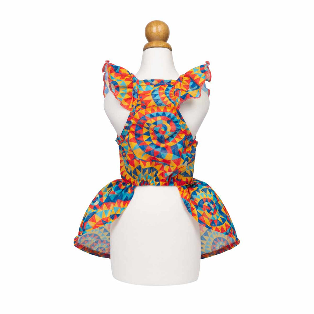 Colorful ruffle dog dresses on a mannequin against a white background