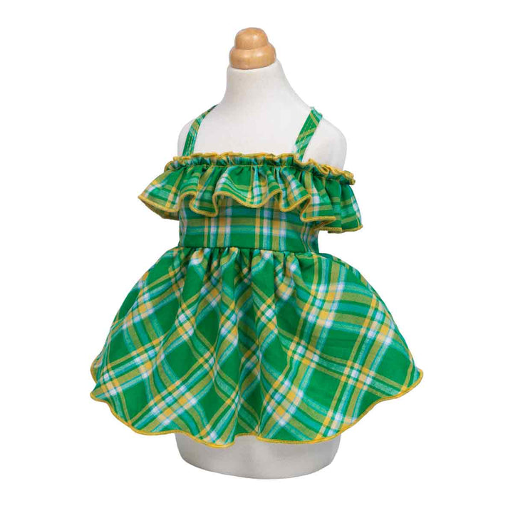 Green plaid dog dress with yellow trim on a mannequin against a white background