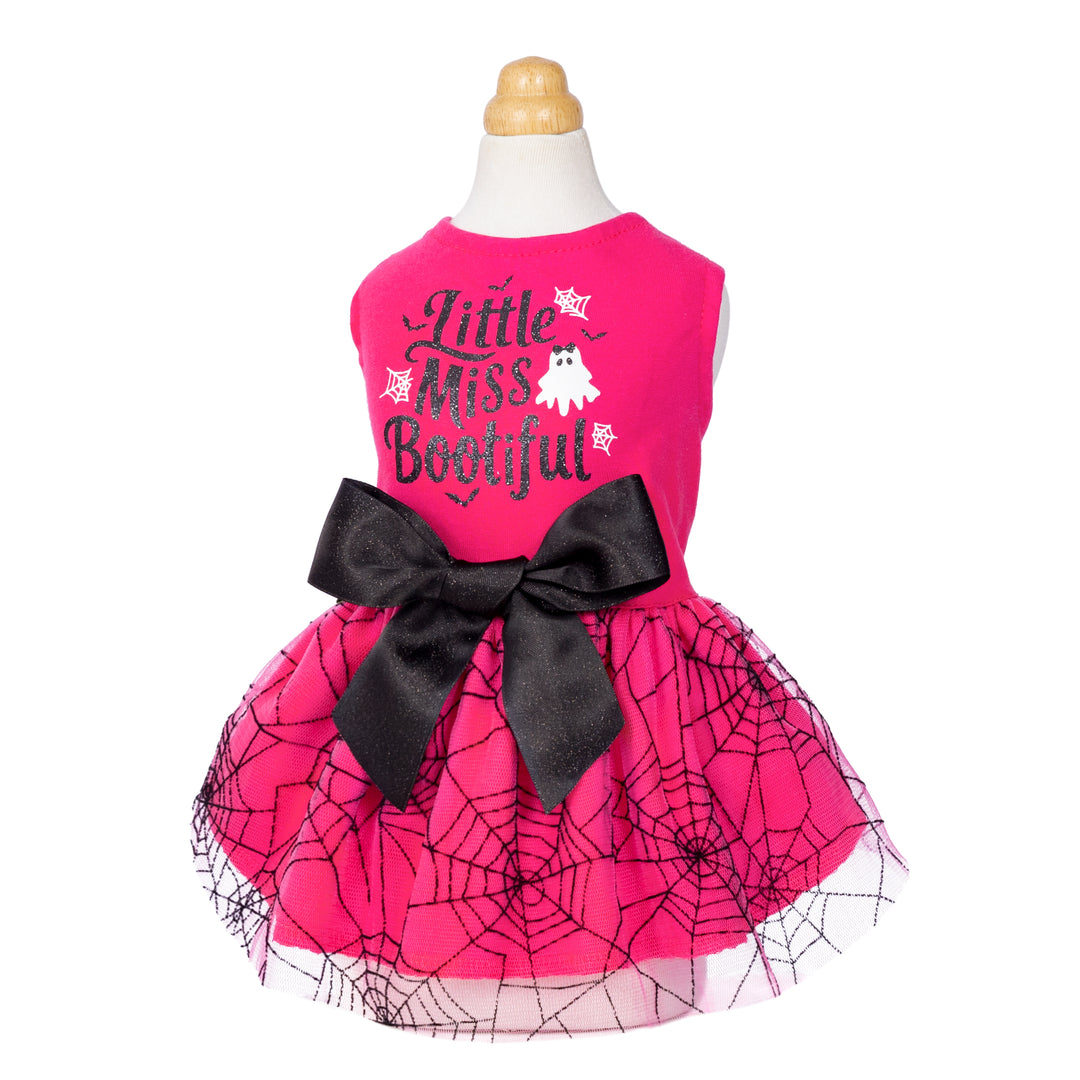 Vibrant pink cotton Halloween dog dress with 'Little Miss Bootiful' text, ghost, black bow, and spiderweb tulle skirt.