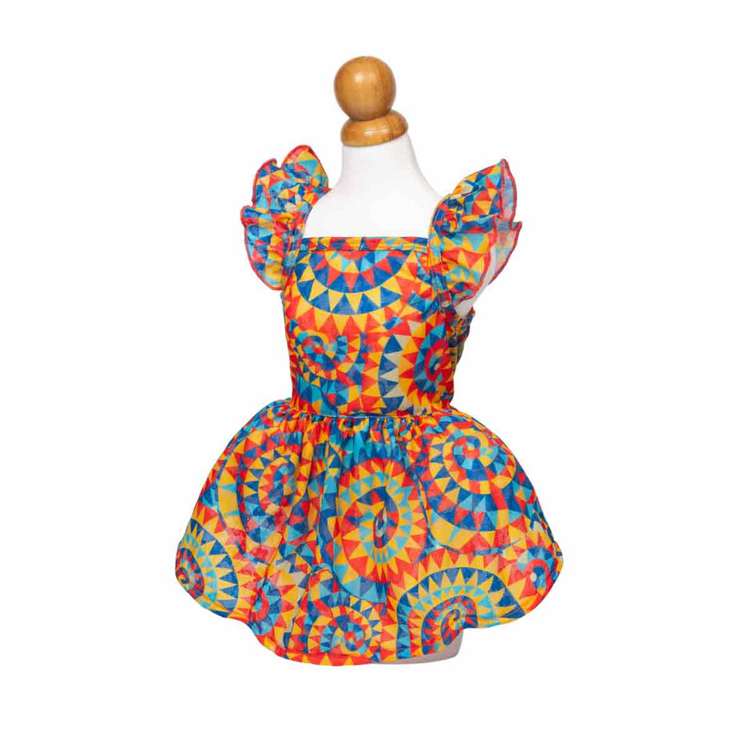 Colorful kaleidoscope dress for dogs on a mannequin against a white background