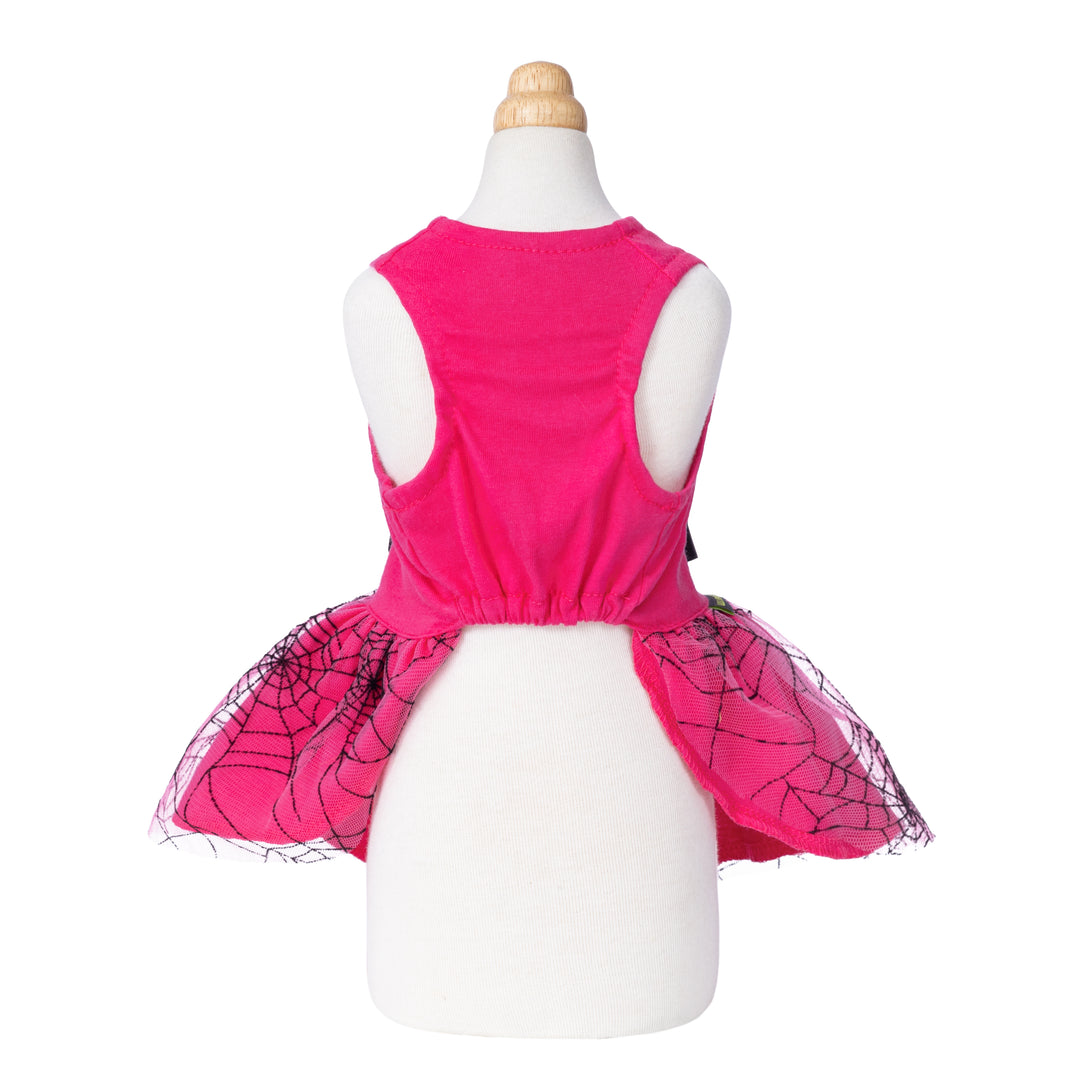 Back view of vibrant pink Halloween dog dress with gathered waist and black spiderweb mesh skirt.