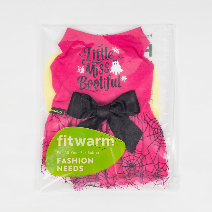 Packaged pink Halloween dog dress featuring 'Little Miss Bootiful' text, ghost, black glitter bow, and spiderweb mesh skirt.
