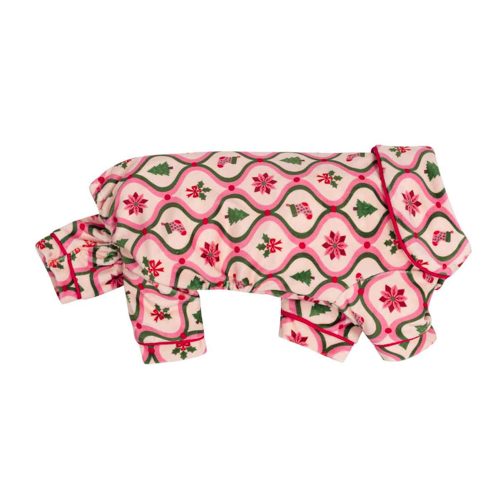 Collared neck dog onesie with a festive Christmas pattern featuring pink and green wavy borders, red poinsettias, and green pine trees on a cream background, shown on a plain white studio background