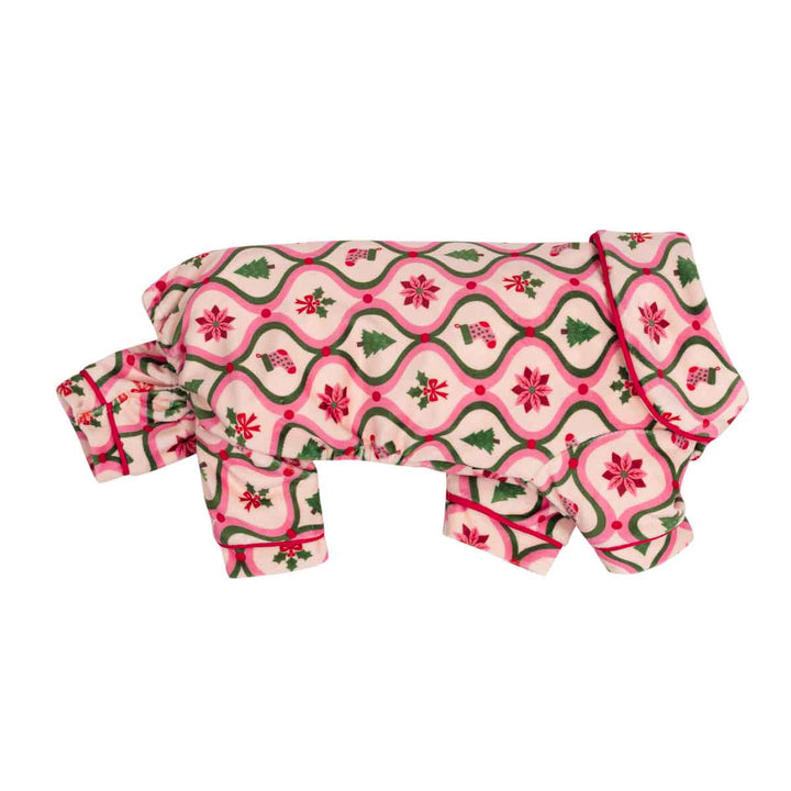 Collared neck dog onesie with a festive Christmas pattern featuring pink and green wavy borders, red poinsettias, and green pine trees on a cream background, shown on a plain white studio background