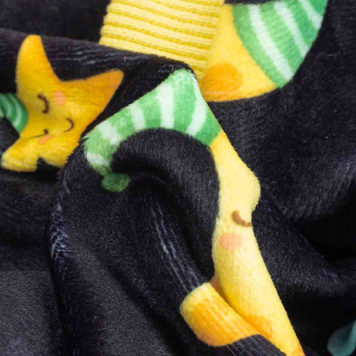 Black dog pajama fabric with yellow moon, star, and green stripe pattern.