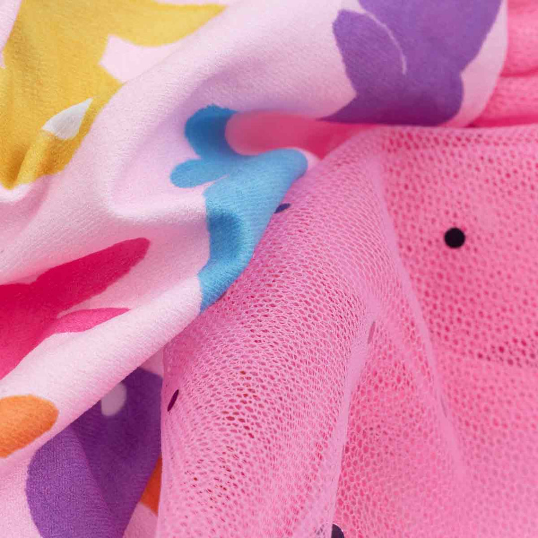 Dog dress with a colorful bunny print, showing front and back views and soft fabric texture.