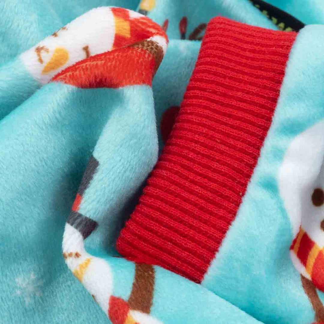 Close-up of dog pajamas fabric showing soft lightweight velvet with red ribbed trim and snowman pattern.