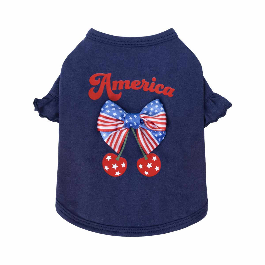 Navy blue dog t shirt with American flag bow and cherries on a white background