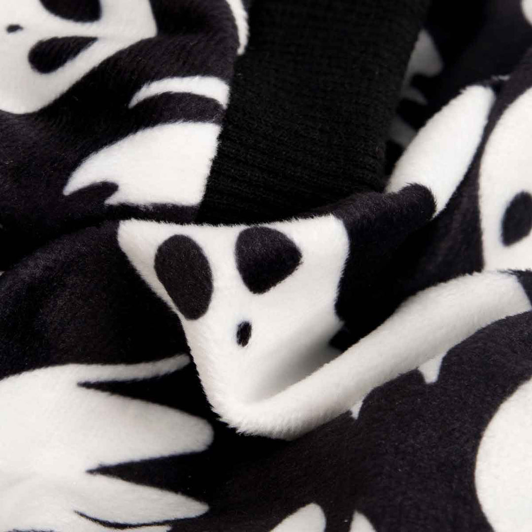 Soft black polyester fabric with white ghost print for Halloween dog pajamas, showcasing ribbed cuffs.