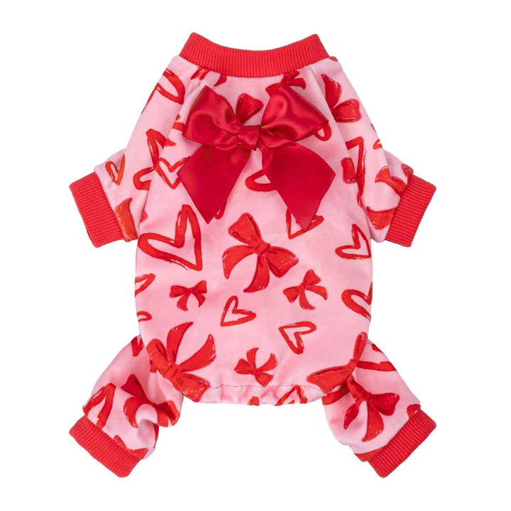 Front view of pink heart and bow dog pajamas with satin bow accent and red cuffs