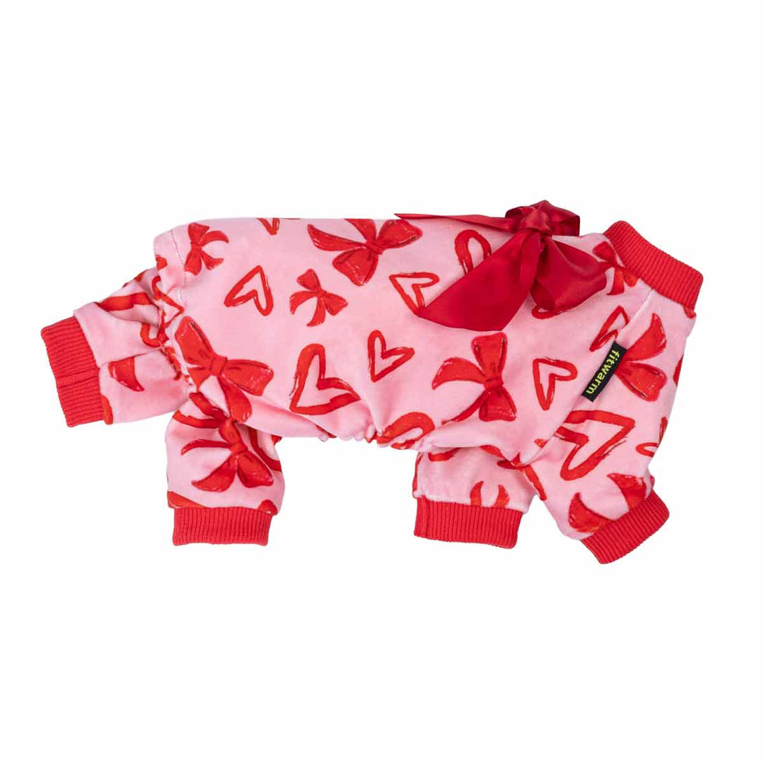 Side view of pink heart and bow dog pajamas with satin bow and red ribbed cuffs