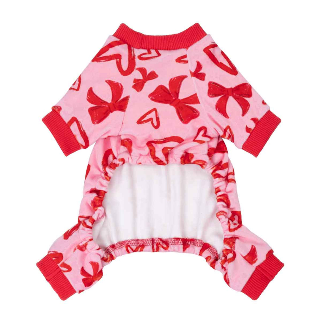 Back view of pink heart and bow dog pajamas with open belly and red ribbed cuffs