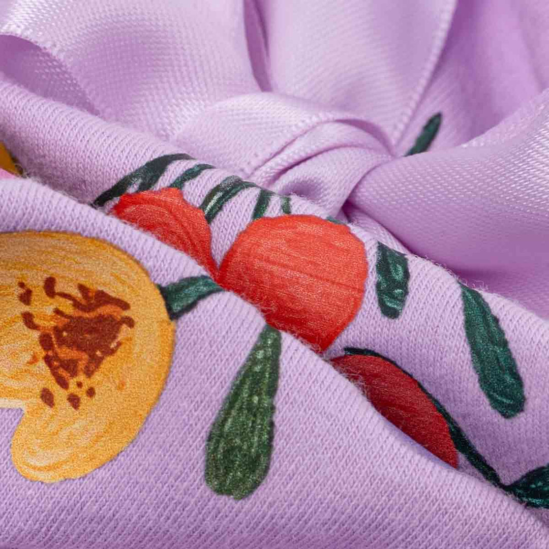 Close up of floral print fabric texture on soft purple dog shirt for dogs