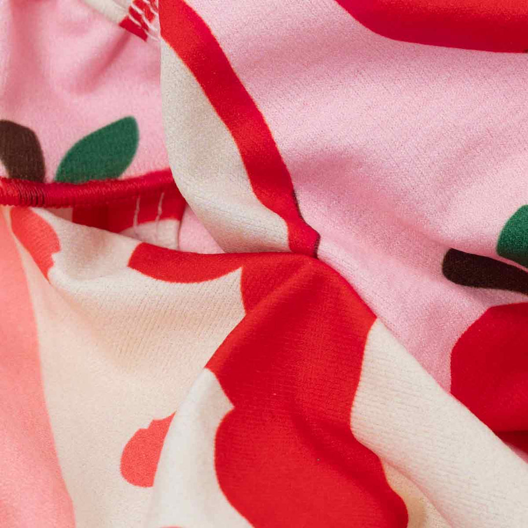 Close up of apple print fabric detail on pink dog shirt for dogs