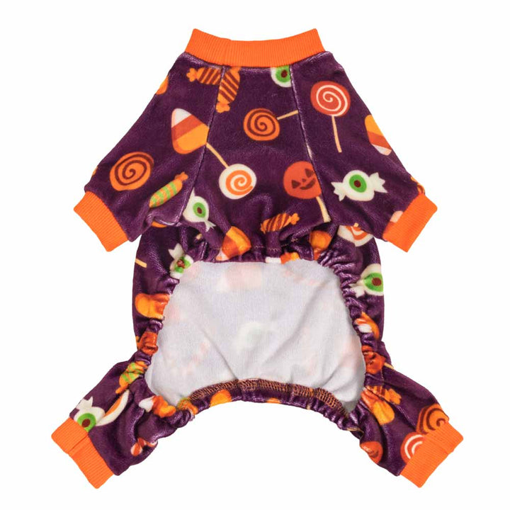 Plush purple Halloween dog PJs with candy corn, lollipop, and jack-o'-lantern prints; orange cuffs.