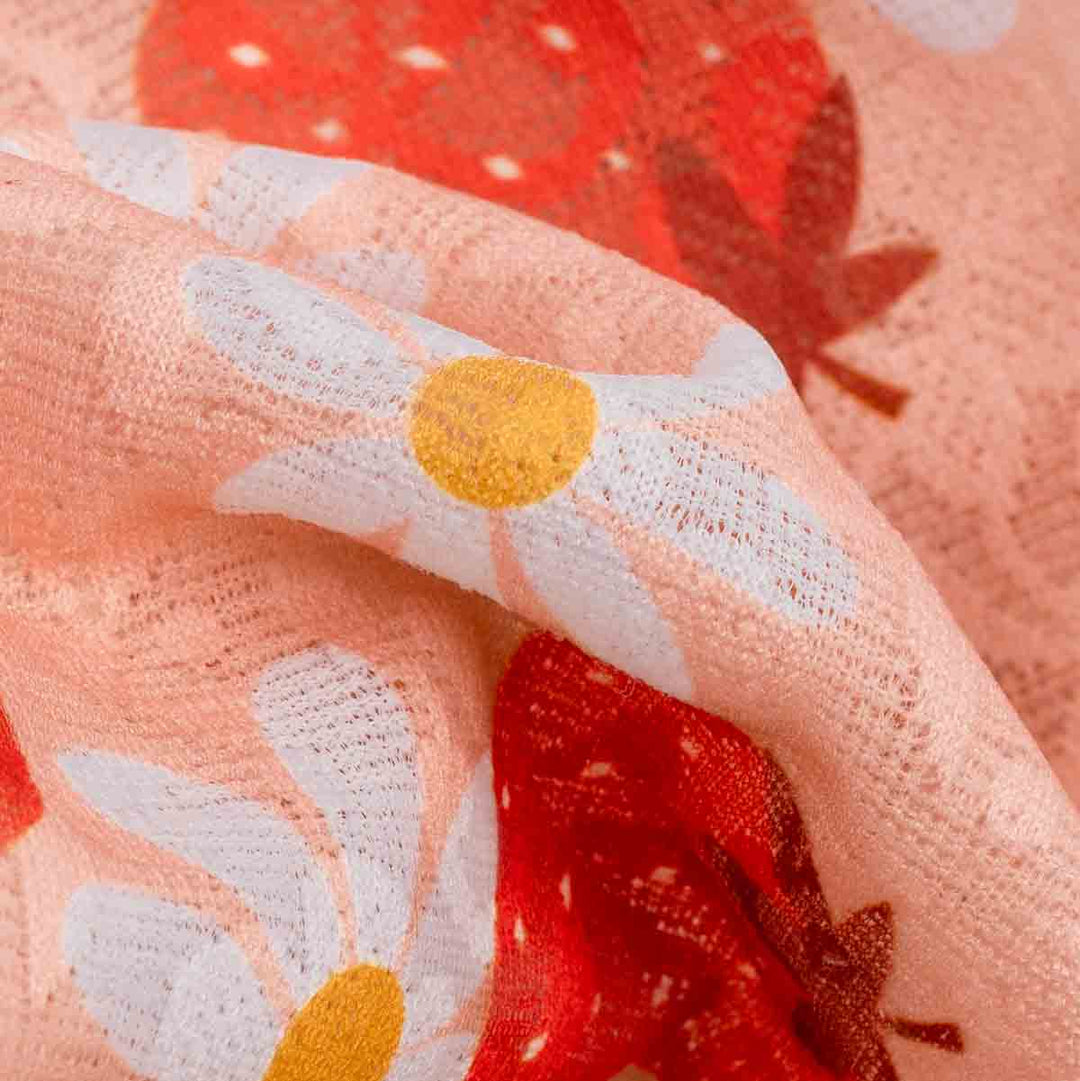 Close-up of a fabric with floral patterns on a pink background
