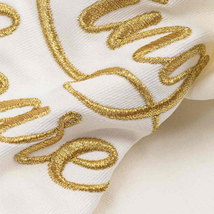 Close up of gold embroidered Ring Bearer lettering on white dog bandanas
