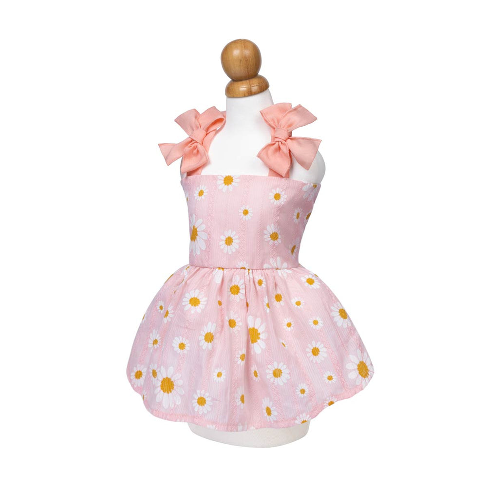 Pink dress for dogs with yellow flowers and large bows on a mannequin against a white background