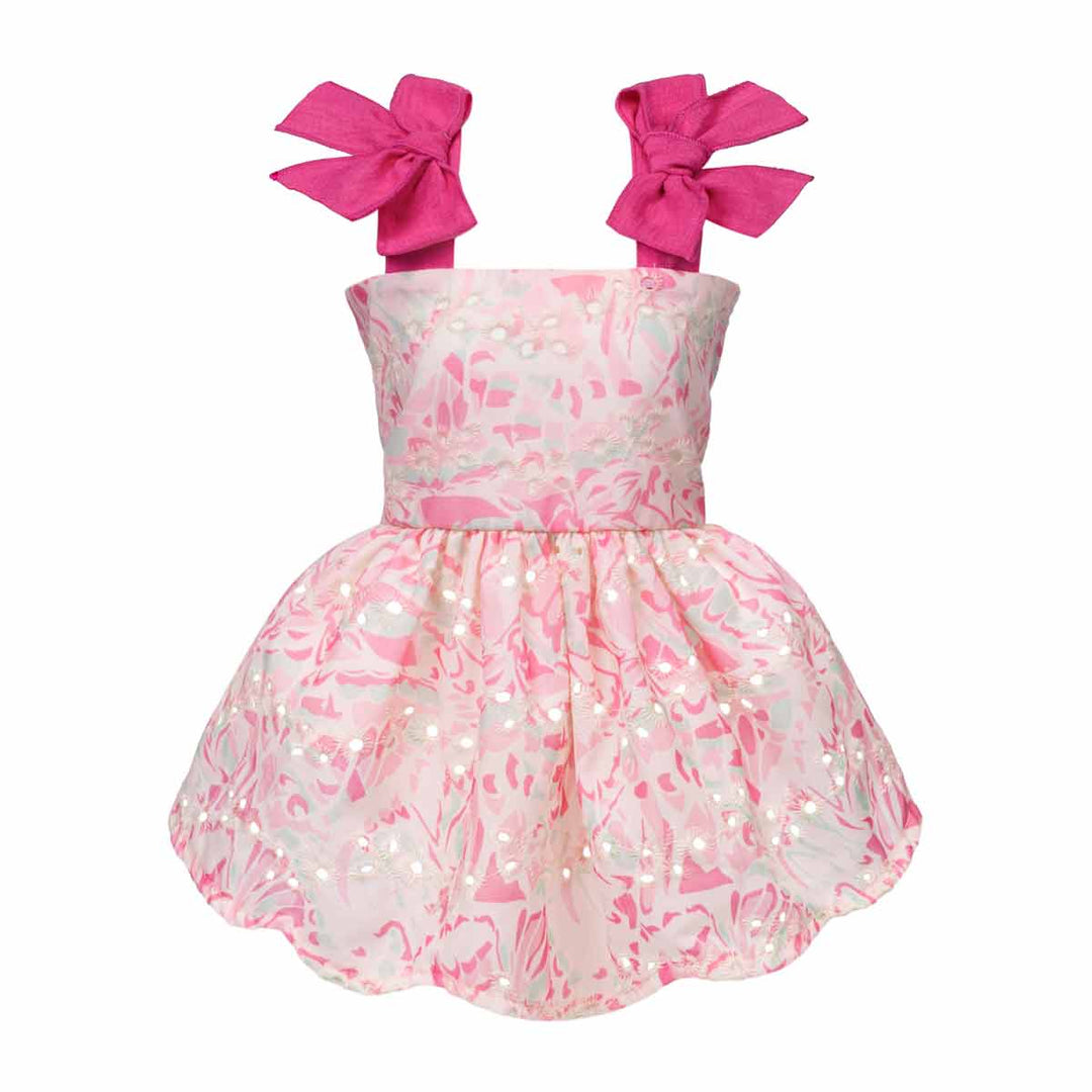 Pink and white dress for dogs with large bows on a white background