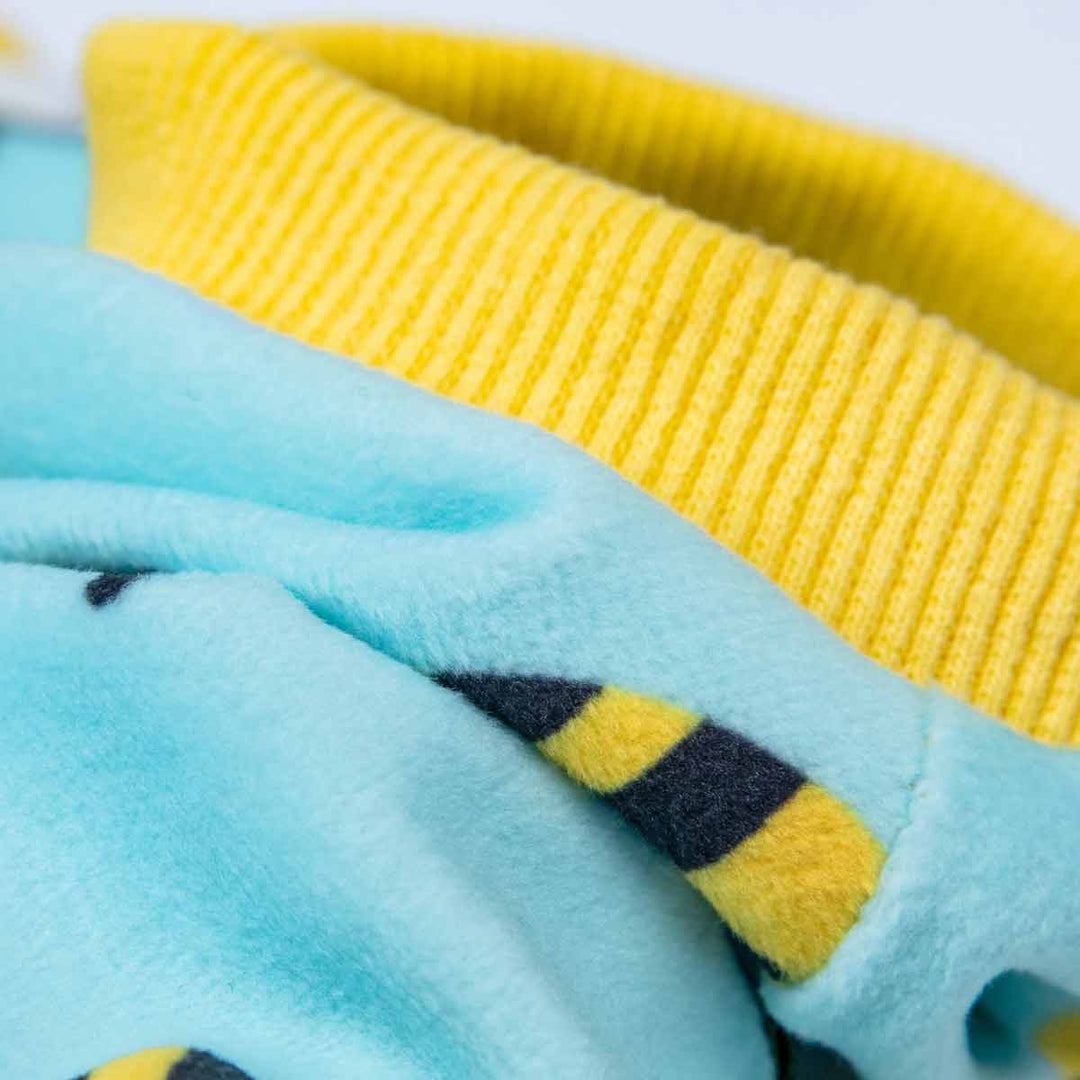 Close-up of blue fuzzy dog pajamas with black and yellow bee stripes and a yellow ribbed collar.
