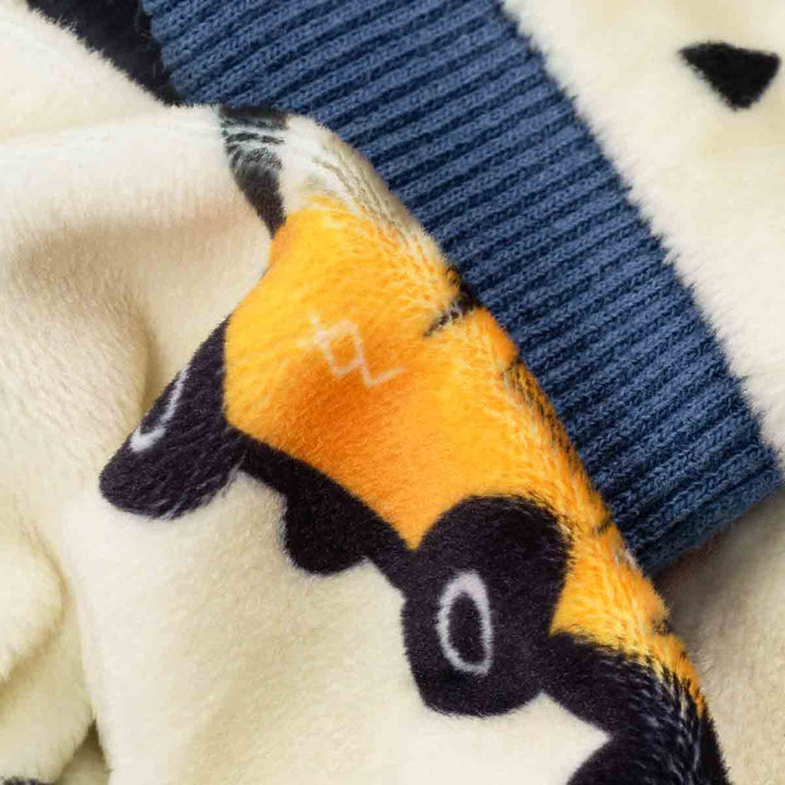 Close-up of a knitted cuffs with a car pattern on a soft fabric background