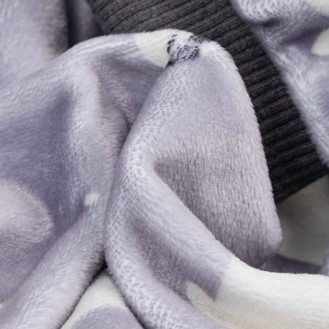 Close-up of a textured fabric with a seal pattern, featuring black cuffs