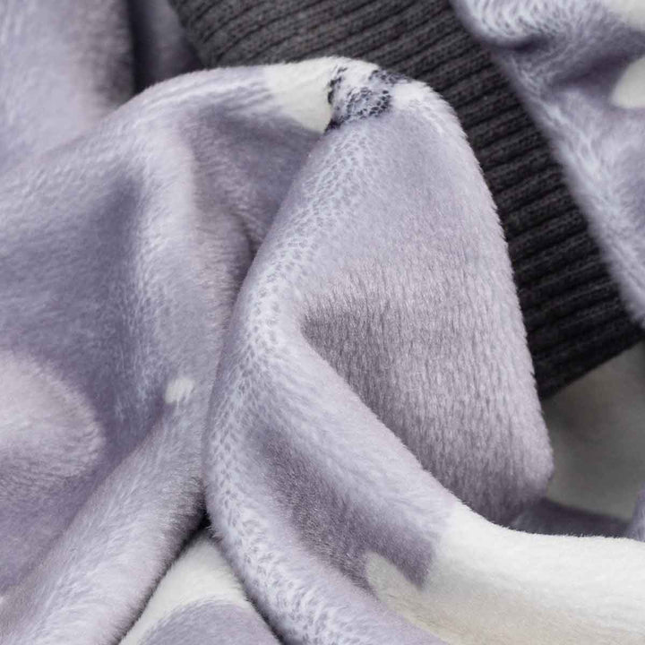 Close-up of a textured fabric with a seal pattern, featuring black cuffs