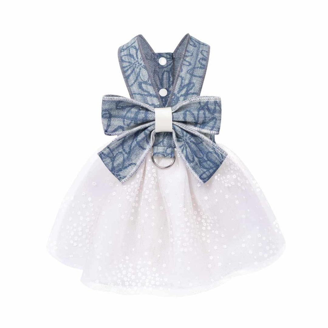 Small denim dog harness dress with a bow on a white background
