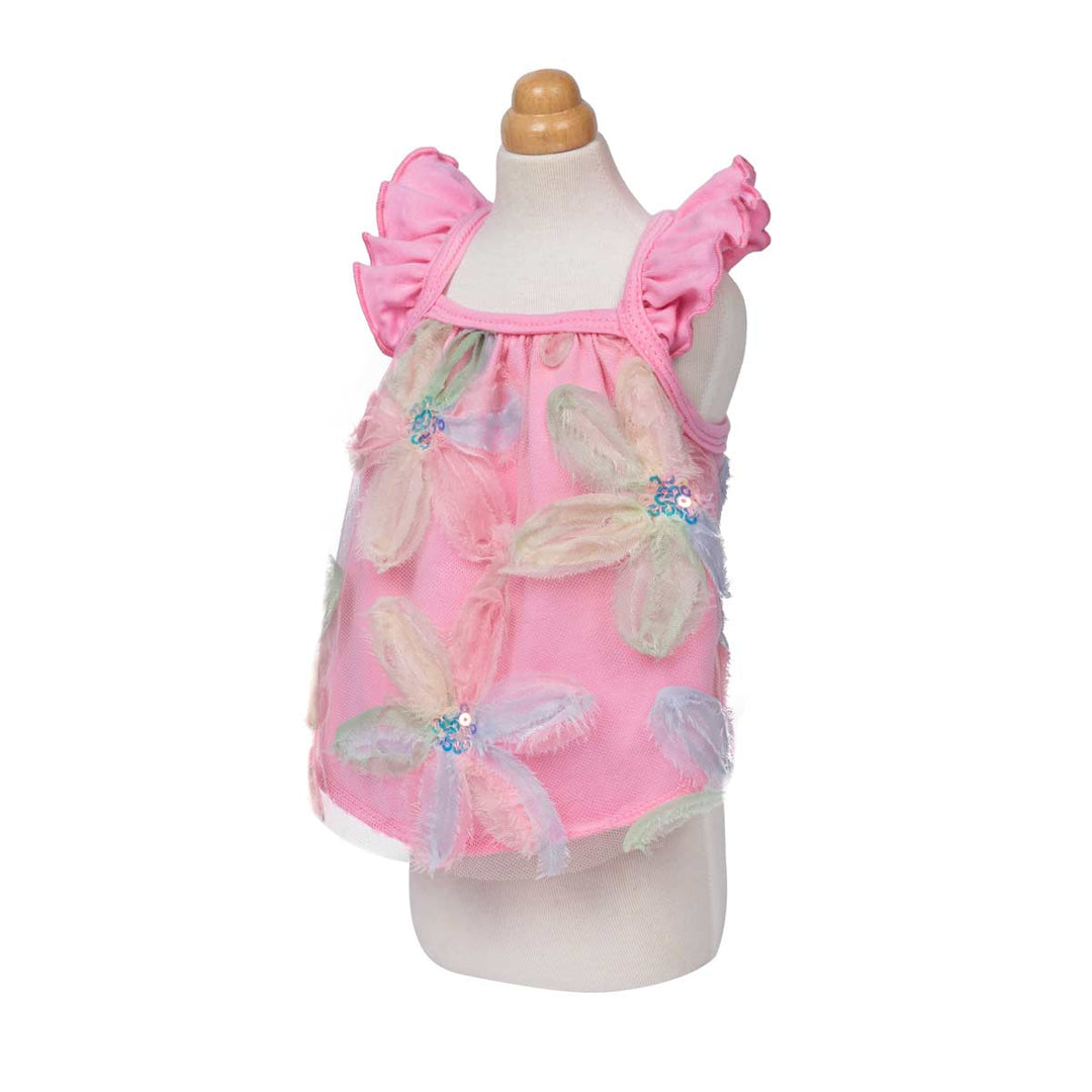 Pink shirt for dogs with ruffle sleeves designs on a mannequin against a white background